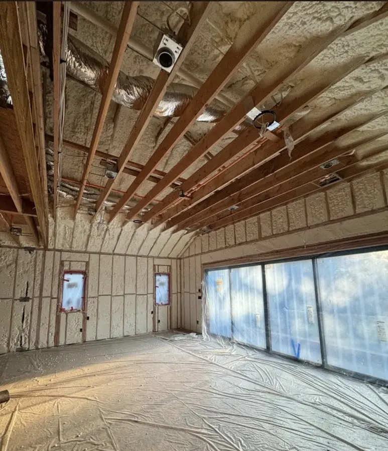 Interior walls and ceiling insulated with spray foam during new construction in Boston